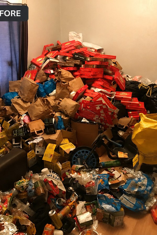 A room full of crates and belongings before a landlord clearance in Gretna